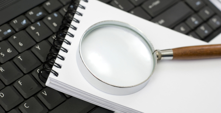 magnifying glass on a notepad