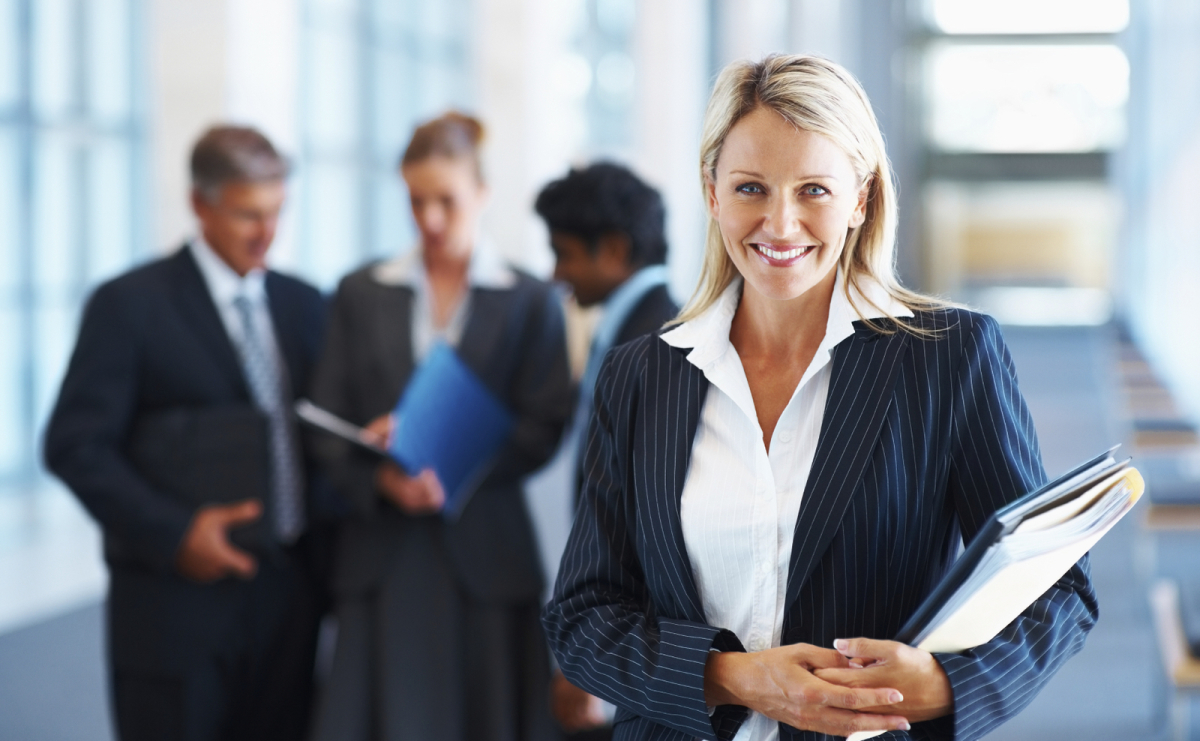 woman in a suit holding a notebook